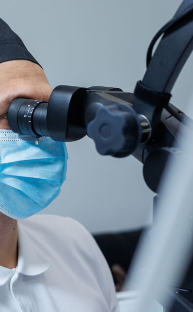 dentist looking through microscope